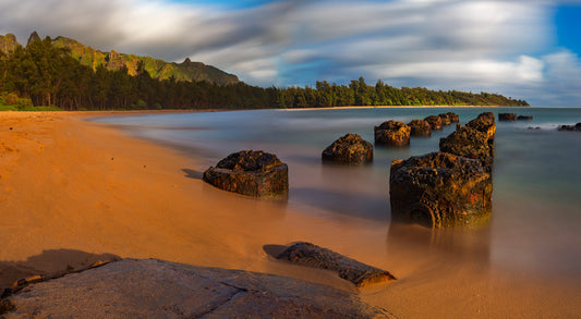 Fine art photograph of the ruins of Anahola Landing on Kauai- pilings in the sand by the water. Scenic photograph by Inspiring Images Hawaii.