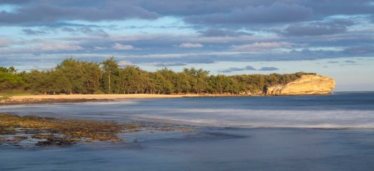 Kauai’s Shipwrecks Beach is illuminated by the evening sun.