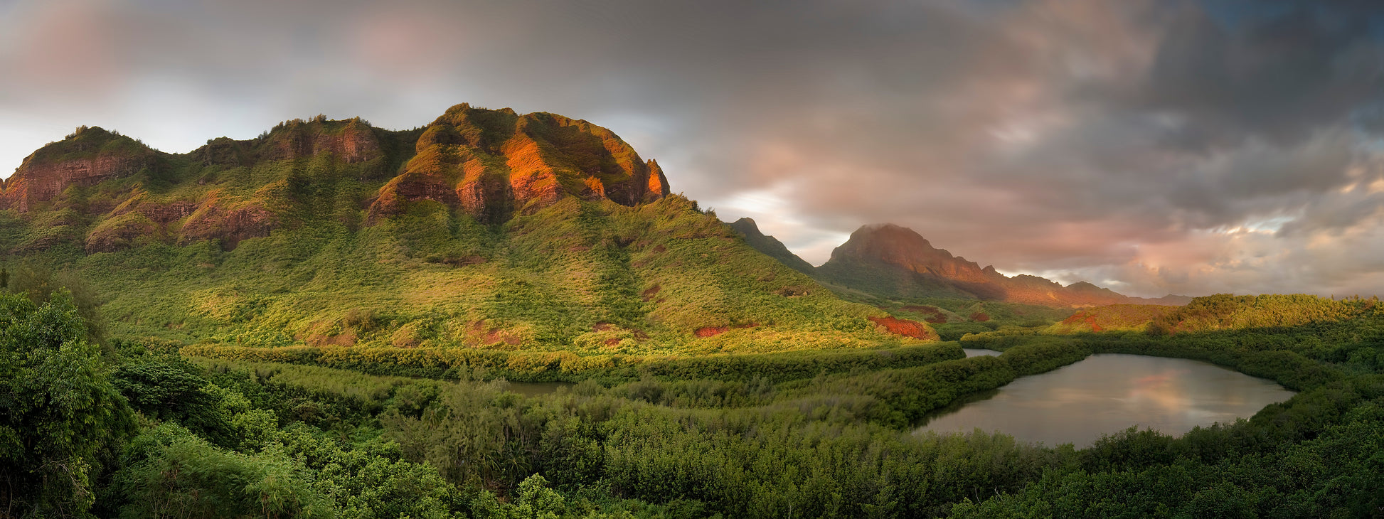 Fine art photograph of Kauai’s Menehune Fish Pond. The ancient fish pond and stream are surrounded by mangrove trees, with mountain range in the background. Landscape photography by Inspiring Images Hawaii.