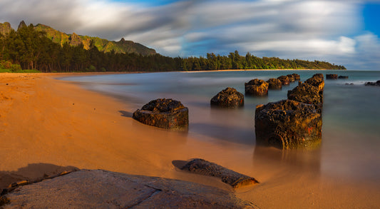 Fine art photograph of the ruins of Anahola Landing on Kauai- pilings in the sand by the water. Scenic photograph by Inspiring Images Hawaii. 
