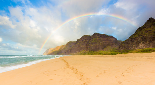 A rainbow frames Polihale Bech and cliffs in this fine art photograph by Kauai landscape photographers Inspiring Images Hawaii.